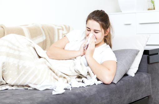 Femme alitée souffrant de la grippe (© Artfoliophoto/Thinkstockphotos) width=